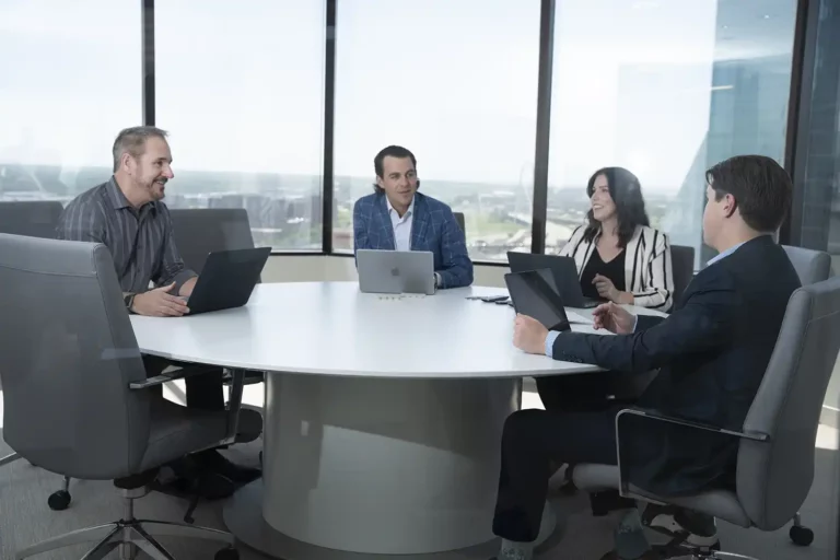 A group of people sitting around a round table