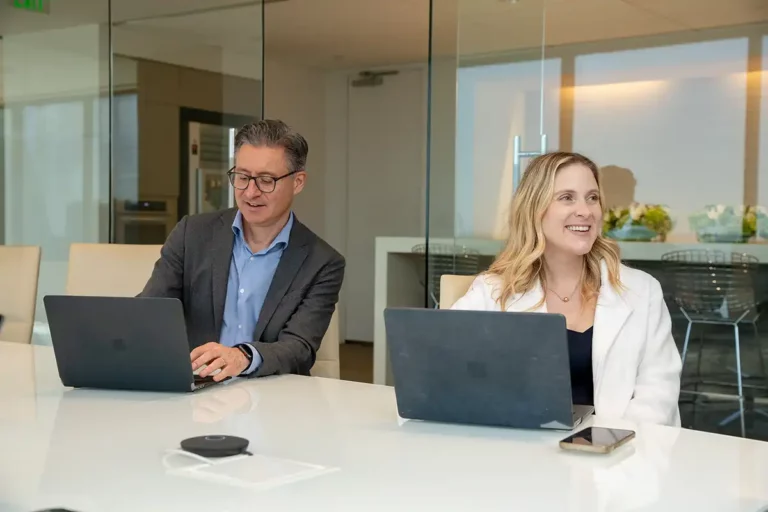 two-avreafoster-employees-smiling-in-meeting