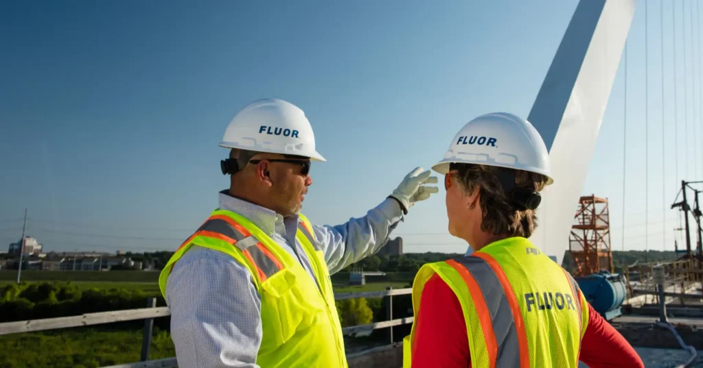 Fluor workers pointing at crane
