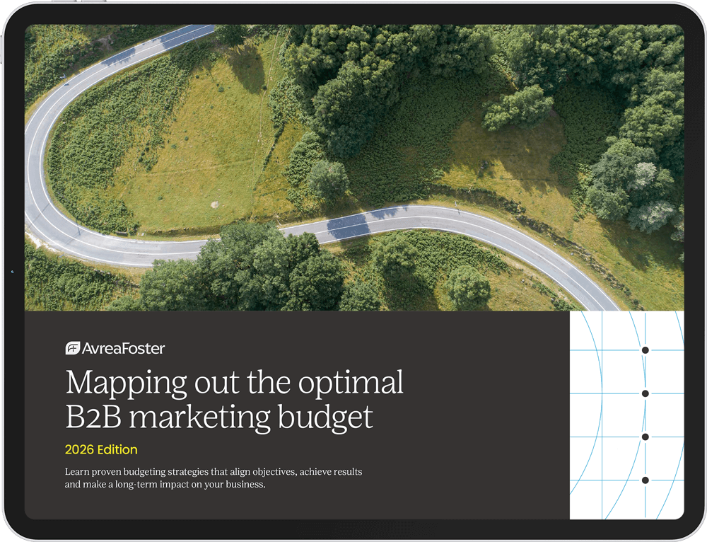 Aerial view of a car driving through a winding road in the forest.