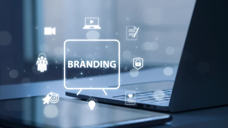 Blue-toned laptop with eight illustrated icons outlining the branding process, suggesting people, ideas, research and documentation.