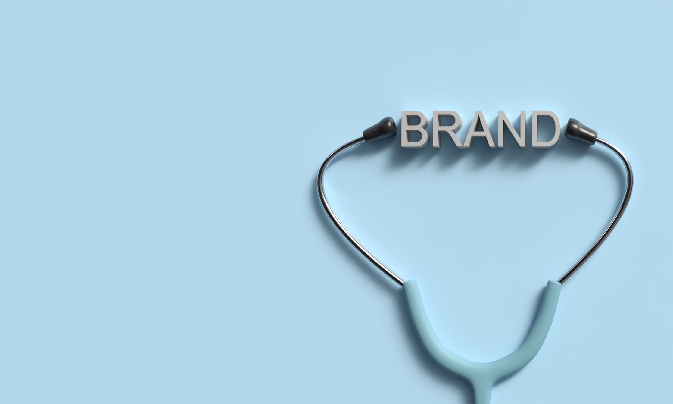 A medical stethoscope set against a sky blue backdrop, the eartips open around the word "brand" as if you suggest listening to it.